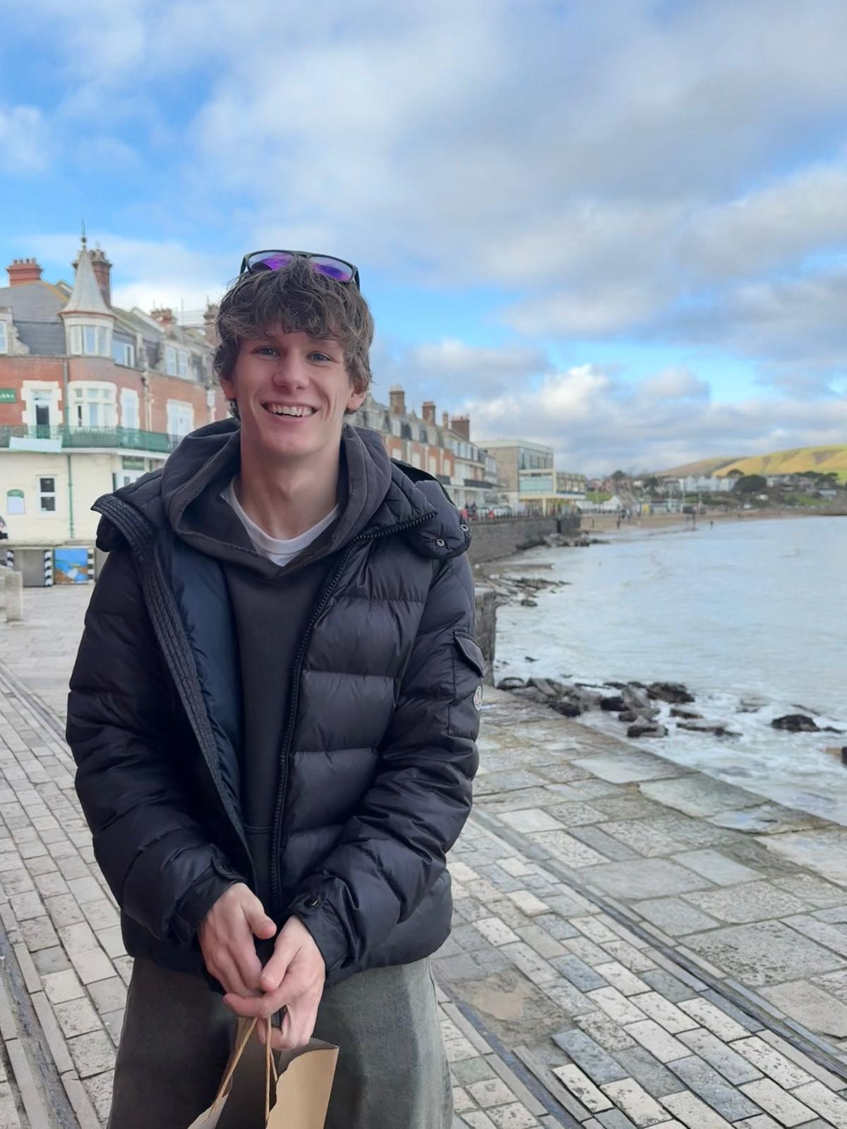 Tom Humphrey smiling by the coast
